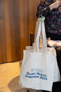 Global Health Symposium bags hanging on rack