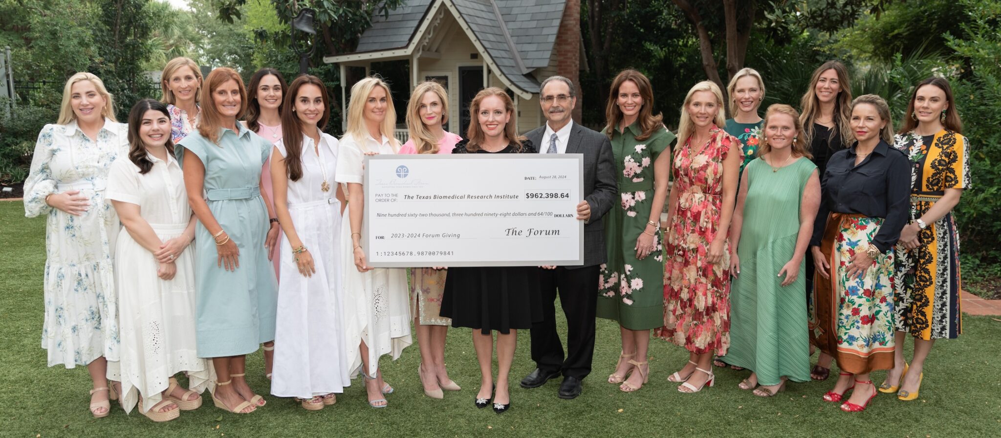 Image of a large check being presented by a group of women to Texas Biomed President/CEO Larry Schlesinger.