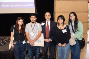Valero Young Scientists attending GHS stand with Dr. Larry Schlesinger
