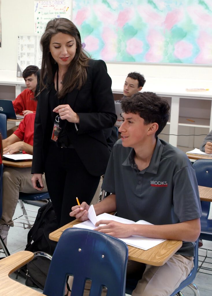 Health science teacher Sarah Hale speaks with Josué Méndez