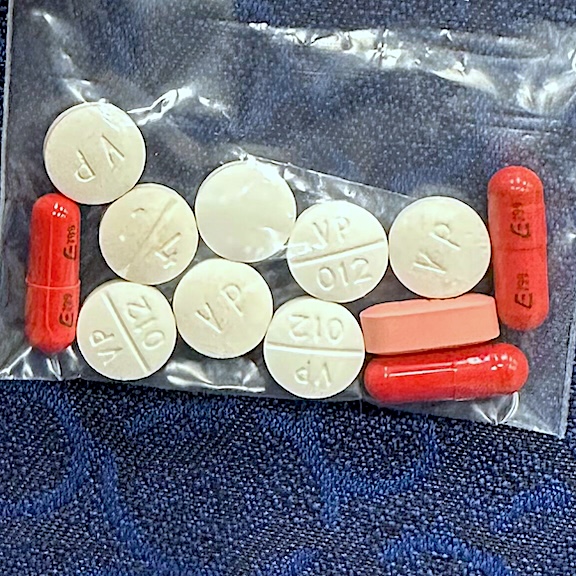 Image of red and white pills for treating tuberculosis.