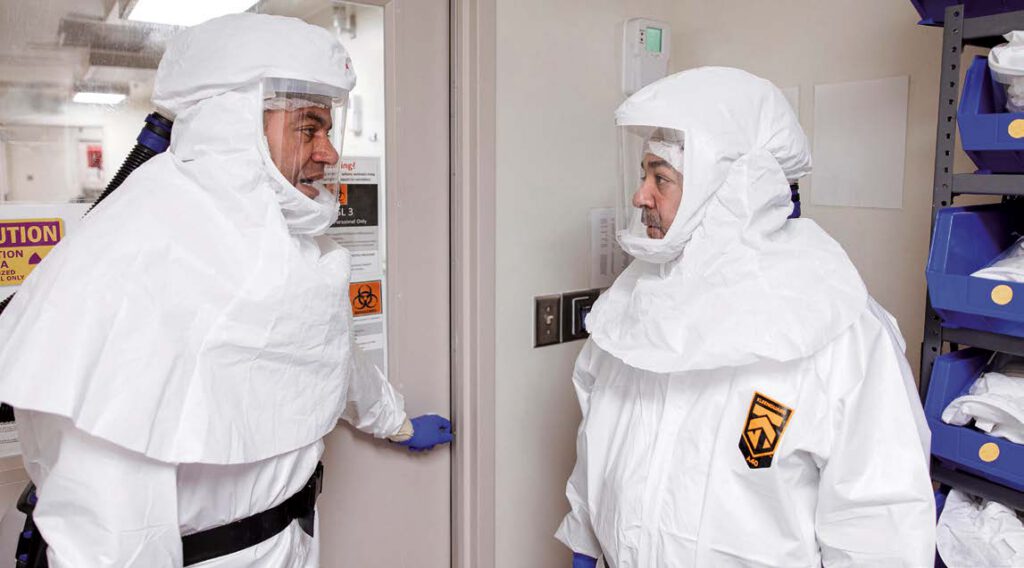 After suiting up in full-body suits, head covers, boots, gloves and turning on their air-purifying respirators, Dr. Elsayed and Dr. Martinez-Sobrido are ready to enter the BSL-3 lab.