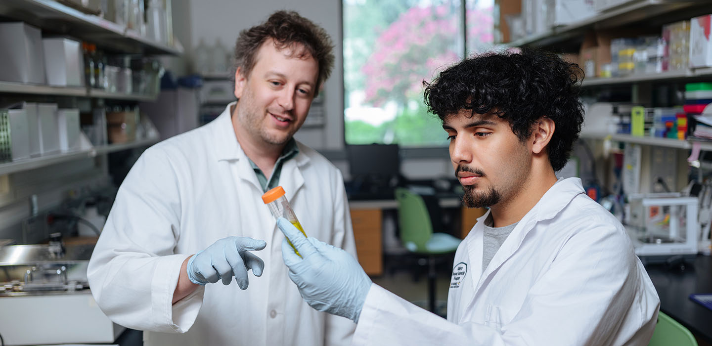 Lead image of Kevin in lab with Aaryn