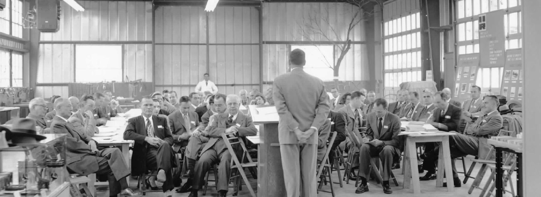 First board meeting with Tom Slick seated on the right of the group